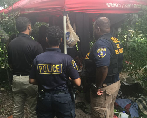 The MSM Police stand in front of a tent