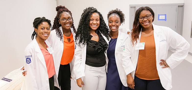 A group of students holding whitecoats for convocation