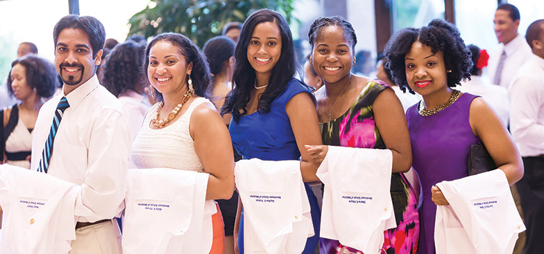 A group of students holding whitecoats for convocation