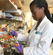 UHSA student in lab coat