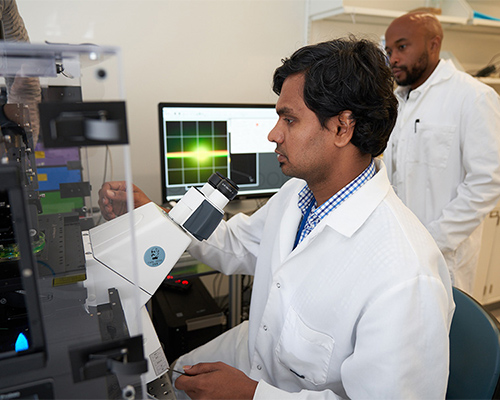 a man uses a machine to run samples