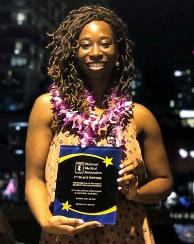 Gail Ohaegbulam receives an award