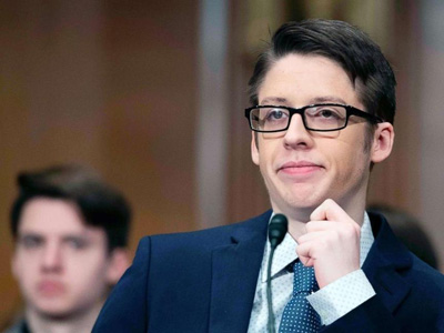 a man talking in a public hearing 