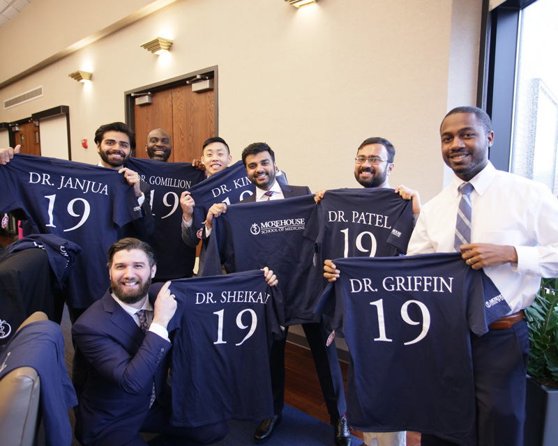 Match Day students hold shirts