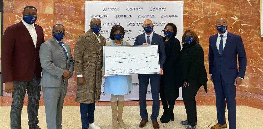 MSM team holding large grant check.