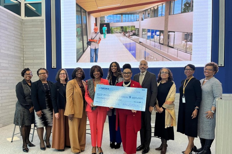 U.S. Rep. Nikema Williams and MSM staff holding a check.