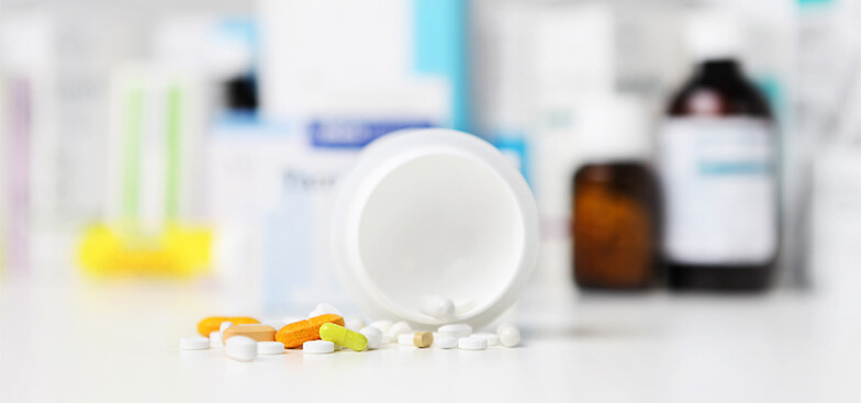 prescription drug pills spread out on a table