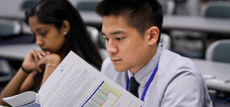 two students reading through charts