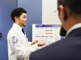 A student presents his research with data and charts