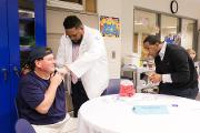 Morehouse School of Medicine Doctor of Medicine Candidate (C’21) Kameron D. Robinson and Andre Harvey, scholar provide flu shots