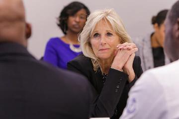 Dr. Jill Biden listens to an MSM student share his personal story about cancer and how has now decided to study it.