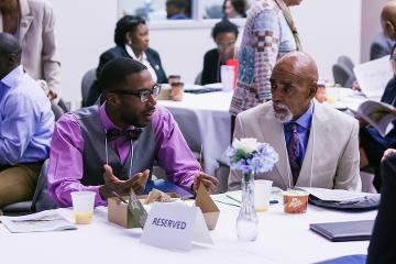 two people discuss a topic at a table