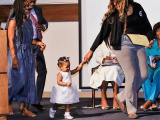 A family walks across the stage for Class Day 2019