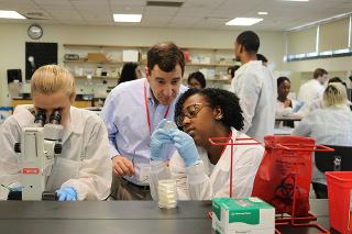 A student takes a close look at a slide