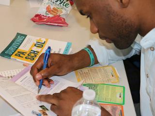 a closeup of a man filling out the True Colors questionnaire 