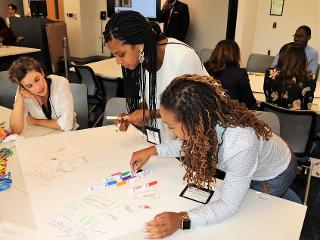 A group works on a poster for their True Colors