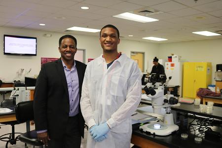 two men stand in a lab