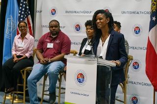 a woman talks at a lectern