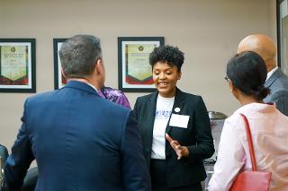 a woman in a suit talks to a group