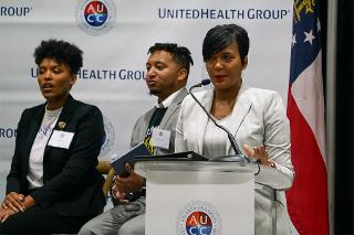 a woman talks at a lectern