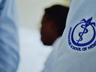 a close up of the Morehouse School of Medicine logo on a whitecoat