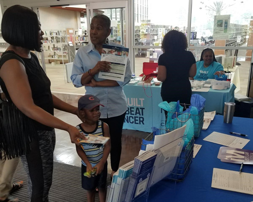 People discussing information at a health fair