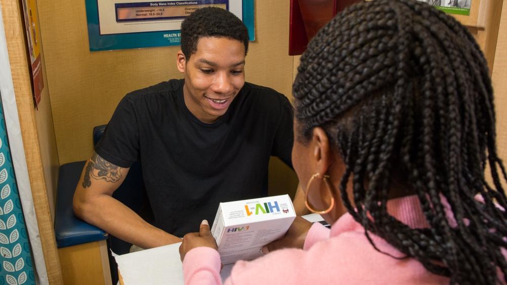 A man receives an HIV-1 test kit