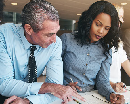 a man and woman work on a document