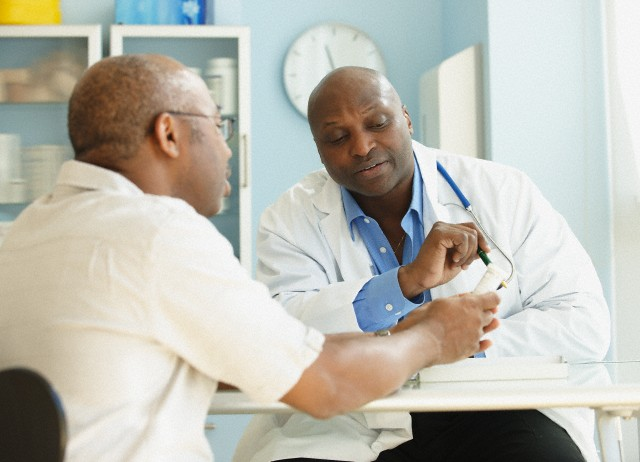 A doctor shows a man results of a test