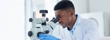 Man looking through microscope