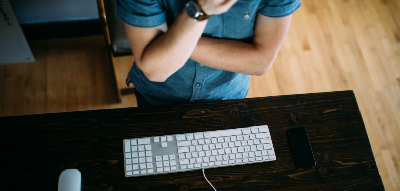 a top view of a person sitting in front of a keyboard