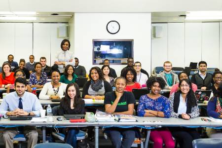 a class full of students smile at the camera